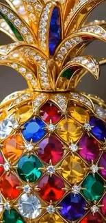 A colorful jeweled pineapple art piece with vibrant gemstones and gold accents.