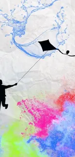 Silhouette of a boy flying a kite with colorful paint splash on textured paper background.