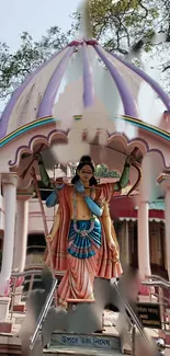 Colorful Krishna statue in temple setting with intricate details.