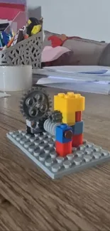 Colorful Lego model with gears on a wooden table.