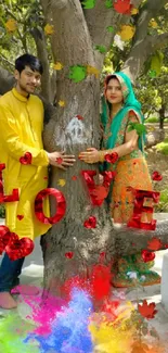 Couple under tree with colorful love decoration.