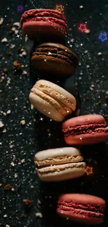 Colorful macarons on a dark, sparkly background.