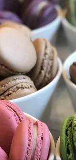 Assorted vibrant macarons in different flavors and colors displayed in bowls.