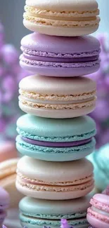 Stack of pastel macarons with floral background.