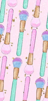 Mobile wallpaper with colorful makeup brushes on pink background.