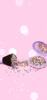 Pink background with makeup brush and colorful sprinkles.