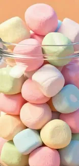 A jar of colorful pastel marshmallows in a vibrant display.