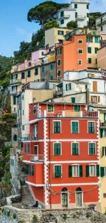 Colorful Mediterranean houses by the sea in vibrant red and green hues.