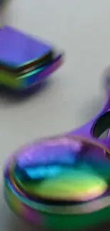 Vibrant iridescent metal spinner with purple, blue, and green hues.