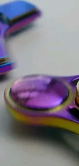 Close-up of a vibrant metallic fidget spinner with purple and yellow hues.