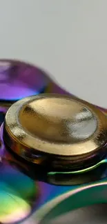 Metallic fidget spinner with vibrant colors and gold accent.