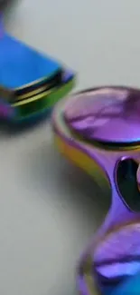 Close-up of a colorful metallic fidget spinner with vibrant hues.