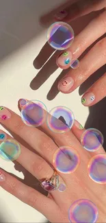 Colorful nail art with rings under sunlight on a beige background.