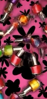 Colorful nail polish bottles on a pink floral background.