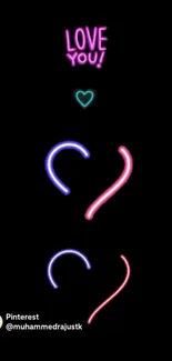 Neon heart design with text on black background.