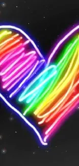 Vibrant neon heart on dark background wallpaper.