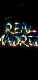 Colorful 'Real Madrid' neon text on black wallpaper.