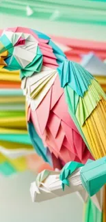 Colorful origami parrot with pink, green, and yellow paper art.