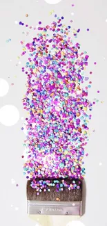 Colorful confetti splash from a paintbrush on white background.