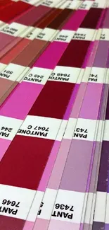 Pantone swatch with red and pink hues covering a table.