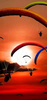 Colorful paragliders soar against a vibrant sunset sky.