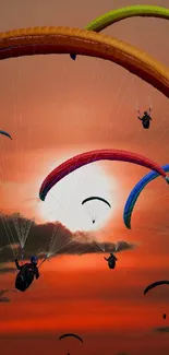 Mobile wallpaper of colorful paragliders against a sunset sky.