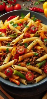 Colorful pasta with tomatoes and peppers on plate.