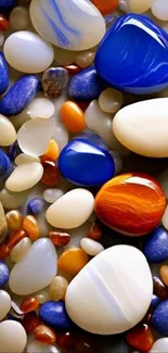 Colorful pebble art with blue, white, and orange stones.