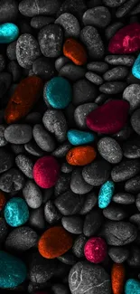 Colorful pebbles on dark background for mobile wallpaper.