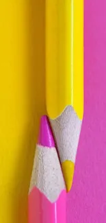 Close-up of vertically stacked pink and yellow pencils with vibrant colors.