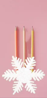 Colorful pencils and snowflake on pink background wallpaper.