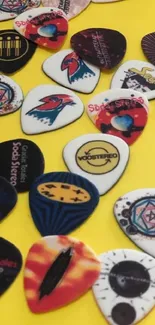 Collage of colorful guitar picks on a vivid yellow background.