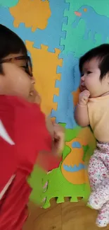 Children playing on colorful foam mats, smiling and interacting.