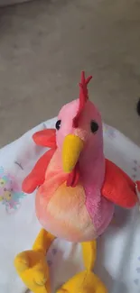 Colorful plush bird toy on soft background.