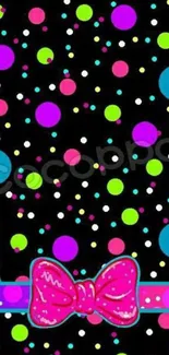 Colorful polka dot wallpaper with pink bow on black background.