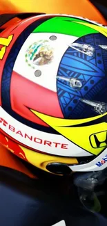 Colorful racing helmet with intricate patterns and sponsor logos.