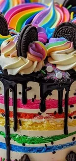 Vibrant rainbow-layered cake with cookies and chocolate drizzle.