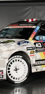 Vibrant rally car with bold multi-color design on white backdrop.