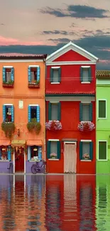 Colorful Italian houses reflecting on water under a stunning sky.