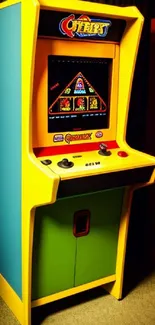 Colorful retro arcade machine with vibrant yellow frame and game display.