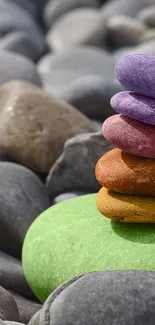 Stack of colorful rocks on smooth pebbles.