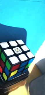 Colorful Rubik's Cube against a blue backdrop.