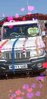 Decorated vehicle with people in traditional attire under a blue sky.