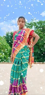 Woman in colorful sari with a snowy effect outdoors.