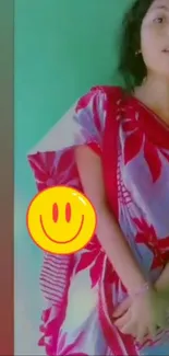 Vibrant sari and smiley face design on phone wallpaper.