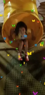 Child playing on a slide with colorful butterflies.