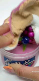 Vibrant slime with colorful orbs in a container.