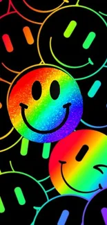 Bright rainbow smiley emoji wallpaper on a black background.