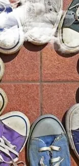 Circle of colorful sneakers on red tile background.