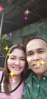 Selfie with colorful star effects and smiling couple in a vibrant setting.